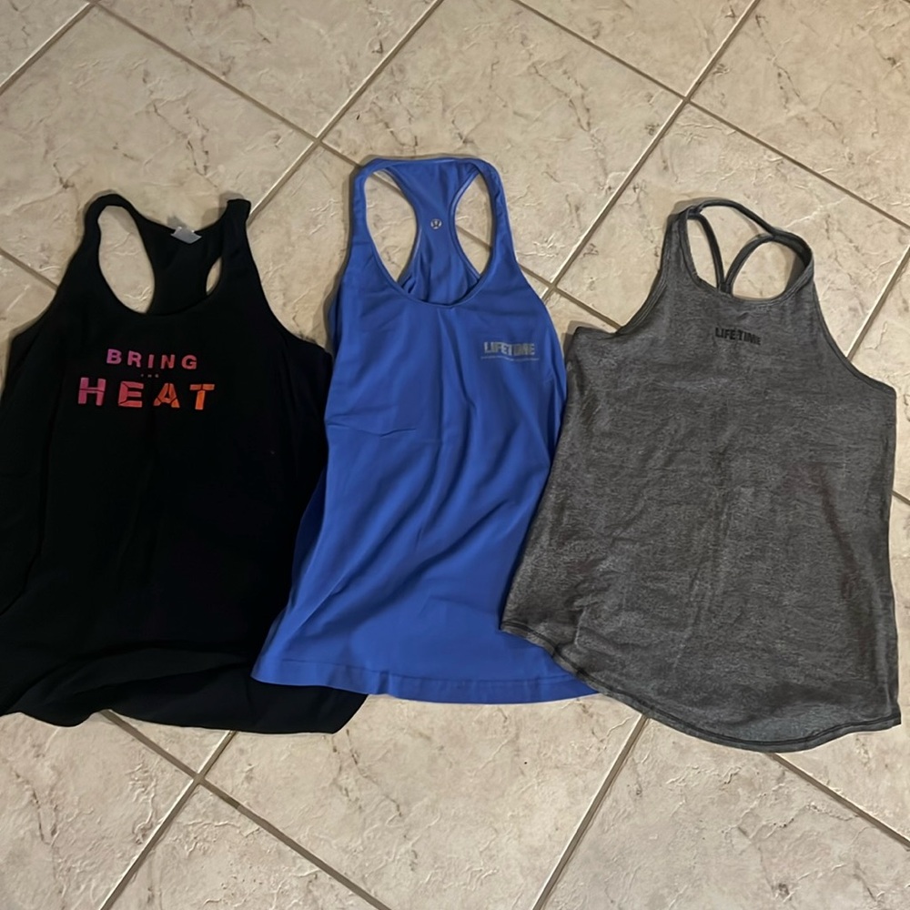 Set of three Lifetime Fitness work out tank tops, including Lululemon